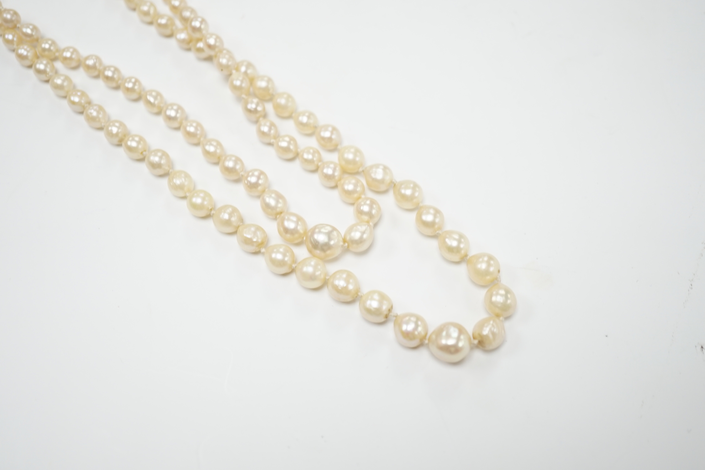 A double strand graduated cultured pearl necklace, with two colour paste set white metal clasp, 39cm.